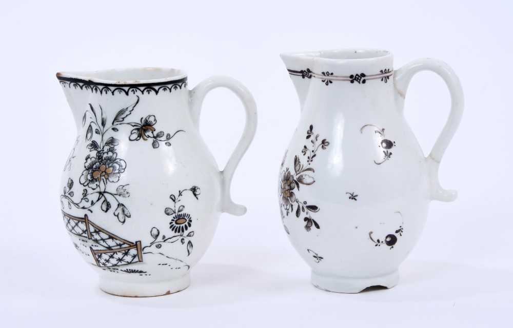 Lot 50 - Two Lowestoft sparrow beak jugs, the first strongly pencilled in black with a Question Mark rock beside a fence and flowering plants, highlighted in gold, loop and line border below rim
