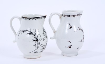 Lot 50 - Two Lowestoft sparrow beak jugs, the first strongly pencilled in black with a Question Mark rock beside a fence and flowering plants, highlighted in gold, loop and line border below rim