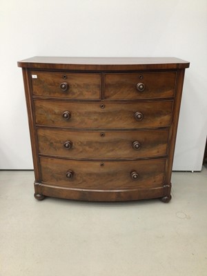 Lot 126 - Victorian mahogany bow front chest of two short and three long graduated drawers with flame mahogany veneers and turned handles on bun feet with castors, 120cm wide x 118cm high x 62cm deep