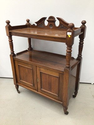 Lot 129 - Late Victorian carved walnut buffet with carved pediment to the back, turned supports and cupboard below enclosed by two panelled doors on turned legs with castors, 90cm wide x 113cm high x 42cm de...