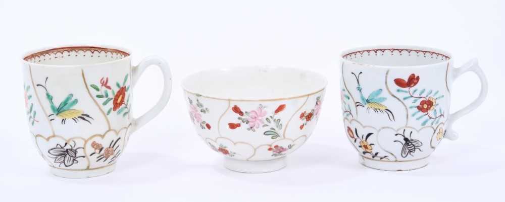 Lot 53 - Lowestoft coffee cup and tea bowl, painted with various insects and flower sprigs within gilded compartments, and a Worcester coffee cup of the same pattern (3)