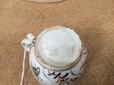 Lot 53 - Lowestoft coffee cup and tea bowl, painted with various insects and flower sprigs within gilded compartments, and a Worcester coffee cup of the same pattern (3)