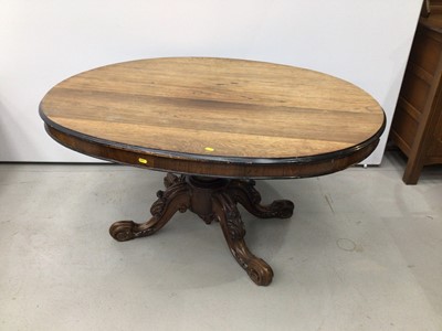 Lot 143 - Nineteenth century rosewood oval tilt top loo table on carved turned column and four carved splayed legs with scroll feet, 130cm x 99cm x 67cm high and a set of four dining chairs