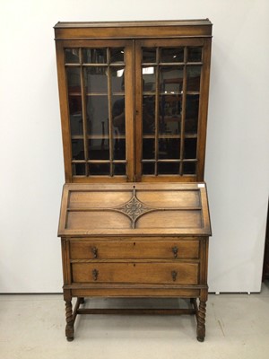 Lot 148 - 1920's oak bureau bookcase with glazed doors above standing on barley twist legs H195cm W90cm D45cm
