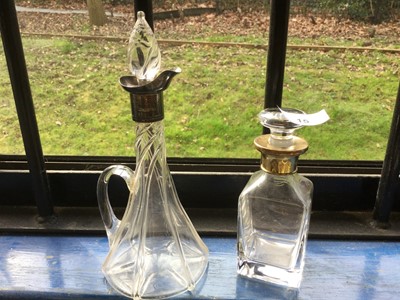 Lot 15 - Silver mounted tapered glass spirit decanter, together with a silver gilt mounted glass scent bottle (2)