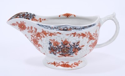 Lot 61 - Lowestoft sauceboat, of large moulded form, painted in blue with flower sprays highlighted in red enamel and gold, 21cm long
