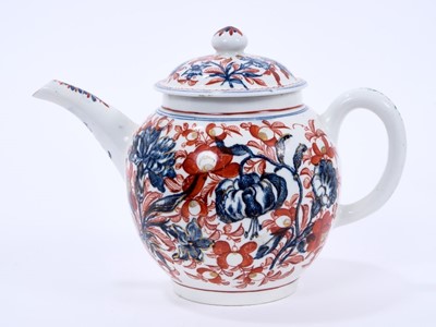Lot 62 - Lowestoft teapot and cover, of globular form with a straight spout and mushroom finial, printed in blue with large scale flower specimens including lilies and carnations, over painted around with f...