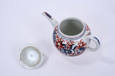 Lot 62 - Lowestoft teapot and cover, of globular form with a straight spout and mushroom finial, printed in blue with large scale flower specimens including lilies and carnations, over painted around with f...