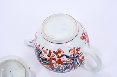 Lot 62 - Lowestoft teapot and cover, of globular form with a straight spout and mushroom finial, printed in blue with large scale flower specimens including lilies and carnations, over painted around with f...