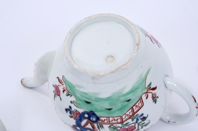 Lot 63 - Large Lowestoft teapot and cover, of globular form with a curved spout and mushroom finial, painted in colours with rockwork and plants within a fenced enclosure, the underglaze blue border with ir...