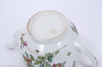 Lot 68 - Lowestoft teapot and cover, of globular form with a flower finial and curved spout, painted in Curtis style with flowers within a red line and loop border, 14cm high