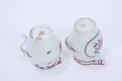 Lot 70 - Two Lowestoft sparrow beak jugs, both painted in the Curtis style with flowers, the first with a puce panel below the spout