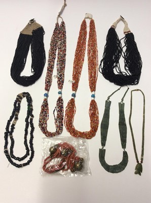 Lot 343 - Two Bondo Tribe micro bead necklaces, other similar style African necklaces and beads