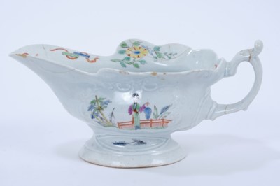 Lot 87 - Worcester silver shaped polychrome sauceboat, c.1755, the body moulded with two cartouches enamelled with chinoiserie scenes, the interior with flowers and precious objects, 19cm length