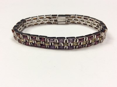 Lot 608 - Multi gem set bracelet with synthetic orange, pink, purple and yellow rectangular stones in white metal setting, 18cm long