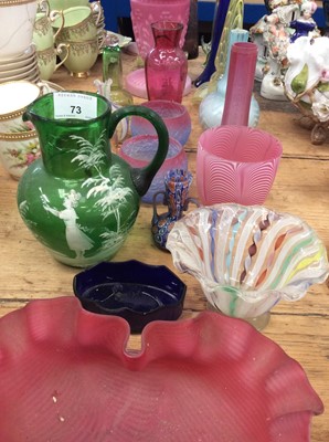Lot 73 - Victorian emerald green glass Mary Gregory style water jug, together with other Victorian and later coloured glassware