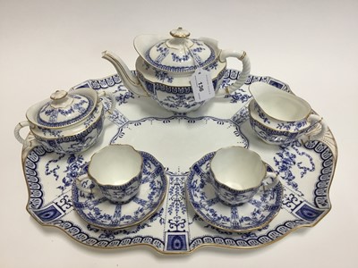 Lot 136 - Two Royal Crown Derby porcelain teasets on trays, one on blue ground, the other on red, 22 pieces