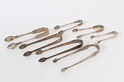 Lot 415 - Pair of George III silver sugar tongs with brightcut engraved decoration, (London 1807), maker Thomas Wallis II, together with six other pairs of Georgian and later silver sugar tongs
