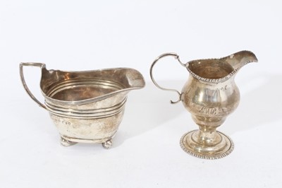 Lot 420 - George III silver cream jug of baluster form with gadrooned borders and scroll handle, raised on domed circular foot, (London 1773), together with another Georgian III silver cream jug