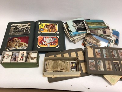 Lot 481 - Box of postcards and cigarette cards, some in albums and some loose, some damp affected