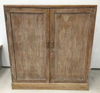 Lot 38 - Three Heals limed oak 'Tilden' chairs, each with drop-in seats and makers plaques, together with a similar dining table, 152cm x 76cm (unmarked) and a similar two door cupboard, lacking shelves, 12...