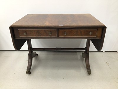 Lot 45 - Late 19th century Georgian-style mahogany sofa table with twin flaps flanking two drawers, on splayed and reeded legs terminating on brass capped castors, 150cm when open x 62cm deep x 69cm high
