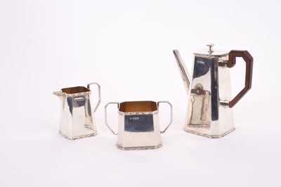 Lot 305 - George V Art Deco silver bachelors coffee set comprising coffee pot of tapered octagonal form, with angular spout, hinged cover and angular bakelite handle, together with matching cream jug and sug...