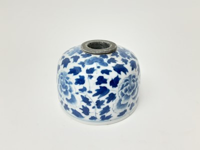 Lot 194 - 19th century Chinese blue and white porcelain inkwell, painted with flowers, seal mark to base, with later removable insert, 8.75cm diameter