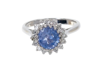 Lot 496 - Sapphire and diamond cluster ring with a round mixed cut cornflower blue sapphire estimated to weigh approximately 1.6cts surrounded by a border of 16 single cut diamonds in claw setting on 18ct wh...