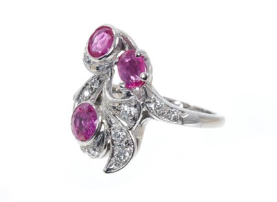 Lot 498 - Art Nouveau style ruby and diamond cocktail ring with three mixed cut rubies, old cut and brilliant cut diamonds in foliate scrolls on 14ct white gold shank. Finger size approximately K.