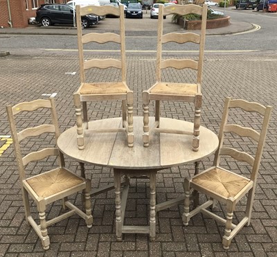 Lot 149 - Limed oak drop leaf table together with a set...