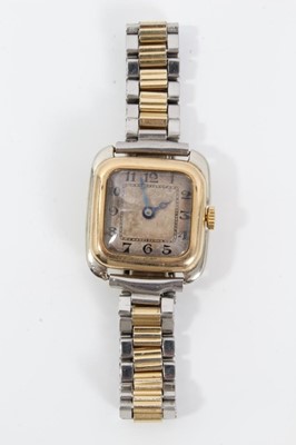 Lot 554 - 1920s gold and stainless steel wristwatch with square silvered dial, black enamel Arabic numerals and blued steel hands, gold bezel and gold winding crown in stainless steel case with 18ct gold bac...
