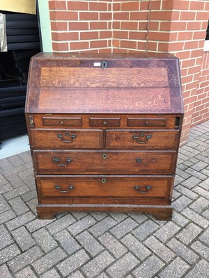 Lot 157 - George III oak bureau with three secret drawers concealed below the bottom drawer