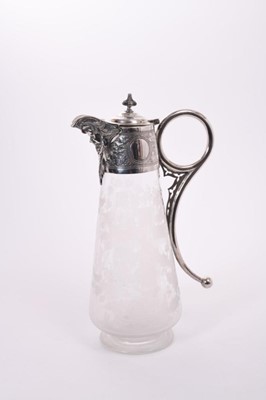 Lot 395 - Victorian glass claret jug of tapered form, with etched decoration of a cross amongst Holly and birds, silver plated mount with engraved scroll decoration, Bacchus mask and domed hinged cover, 29cm...
