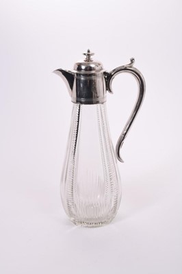 Lot 396 - Victorian cut glass claret jug of baluster form, silver plated mount with reeded decoration and hinged cover, with scroll handle, 29.5cm overall height