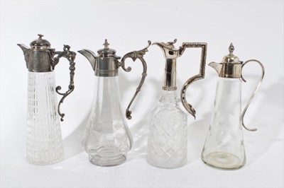 Lot 399 - Victorian cut glass claret jug of tapered form, with star cut decoration and star cut base, silver plated mount and hinged cover, 31cm overall height, together with three other various glass claret...