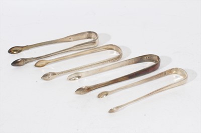 Lot 403 - Pair of George III silver sugar tongs with brightcut engraved decoration, (London 1794), maker Peter & Ann Bateman, together with three other pairs of Georgian silver sugar tongs (various dates and...
