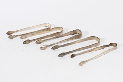 Lot 404 - Pair of George III silver sugar tongs with britecut engraved decoration, (London 1793), maker Peter & Ann Bateman, together with four other pairs of Georgian silver sugar tongs (various dates and m...