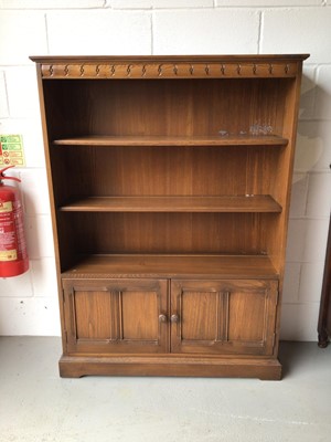 Lot 214 - Ercol elm open bookcase with panelled doors below, 101cm wide, 30.5cm deep, 138cm high