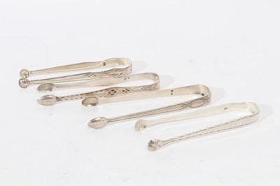 Lot 476 - 4 pairs of George III silver sugar tongs, with bright cut engraved decoration