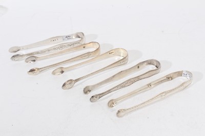 Lot 511 - 5 pairs of George III silver sugar tongs, with bright cut engraved decoration, London circa.