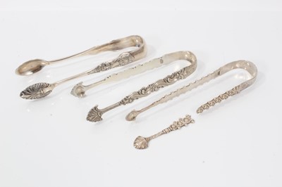 Lot 477 - Pair of George III silver sugar tongs with cast and engraved decoration, London circa. 1770, 13.5cm overall, together with another two pairs of silver sugar tongs, (various dates and makers) (3)