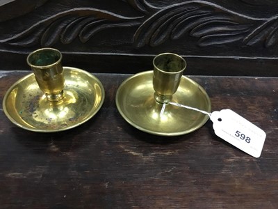 Lot 598 - Antique brass Brighton bun candlesticks of typical form, 9cm diameter. Ex New Hall, Chelmsford