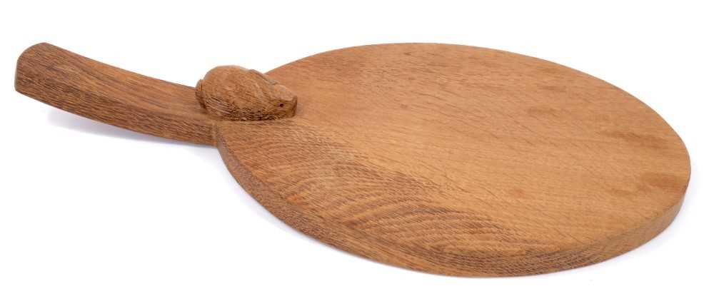 Lot 879 - Peter 'Rabbitman' Heap of Wetwang, oak cheese board of oval form with carved Rabbit signature to the base of the handle.  
N.B. Peter Heap was a former ‘Mouseman’ apprentice, before leaving to set...