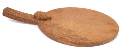 Lot 879 - Peter 'Rabbitman' Heap of Wetwang, oak cheese board of oval form with carved Rabbit signature to the base of the handle.  
N.B. Peter Heap was a former ‘Mouseman’ apprentice, before leaving to set...