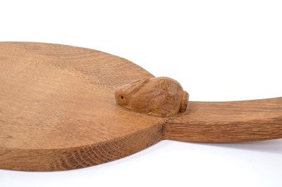 Lot 879 - Peter 'Rabbitman' Heap of Wetwang, oak cheese board of oval form with carved Rabbit signature to the base of the handle.  
N.B. Peter Heap was a former ‘Mouseman’ apprentice, before leaving to set...