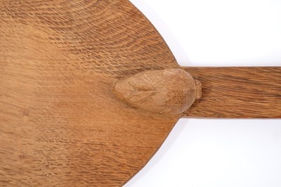 Lot 879 - Peter 'Rabbitman' Heap of Wetwang, oak cheese board of oval form with carved Rabbit signature to the base of the handle.  
N.B. Peter Heap was a former ‘Mouseman’ apprentice, before leaving to set...
