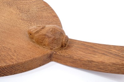 Lot 879 - Peter 'Rabbitman' Heap of Wetwang, oak cheese board of oval form with carved Rabbit signature to the base of the handle.  
N.B. Peter Heap was a former ‘Mouseman’ apprentice, before leaving to set...
