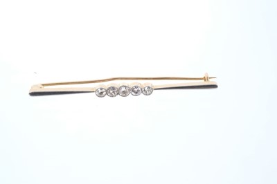 Lot 556 - Edwardian diamond five stone bar brooch with a line of five graduated old cut diamonds in platinum millegrain setting on yellow gold bar. Estimated total diamond weight 0.50cts. Length approximatel...