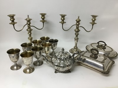 Lot 144 - Victorian silver plated melon shape teapot, two Edwardian silver plated entre dishes and covers, pair of silver plated candelabras and and a set of six silver plated goblets